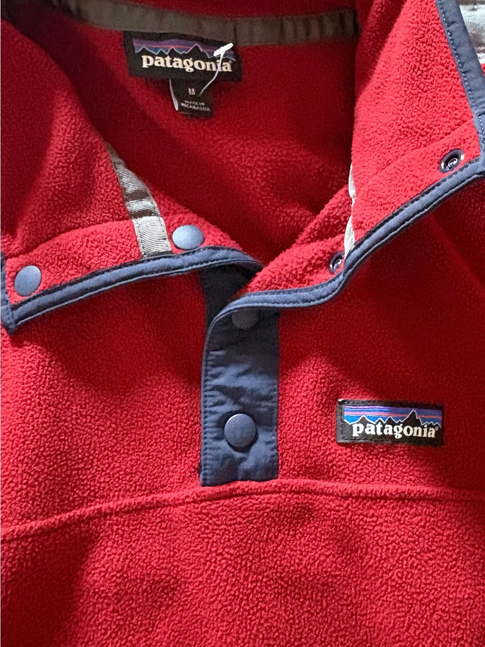 Patagonia red fleece pullover with navy trim